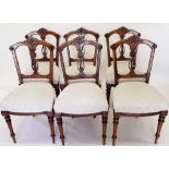 A set of six Victorian dining chairs with decorative carved backs