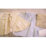 A Victorian cream wool lace confirmation cape, another longer cream cape, blue satin nightdress