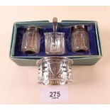 A glass and silver cruet set and a silver napkin ring