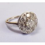 A good platinum set diamond cluster ring, the central stone approx 0.7 carat with eight stone