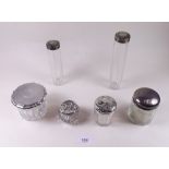 Six assorted dressing table jars with silver lids