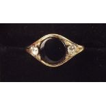 A 9 carat gold ring set black onyx flanked by cubic zirconium
