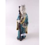 An 19th century Chinese pottery figure of a scholar - 25cm