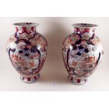 A pair of 19th century Japanese large Imari vases painted garden scenes, one rim repaired - 36cm