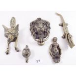 A group of brass door knockers and a pair of nut crackers