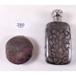 A silver compact decorated Japanese landscape and a silver clad toiletry bottle