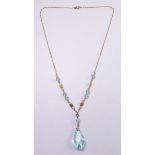 An Edwardian 9 carat gold necklace with blue stone pendant