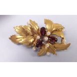 A 9 carat gold garnet and seed pearl leaf brooch