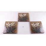 Three floral painted tiles