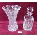 A cut glass decanter and a cut glass vase