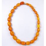 A short string of amber beads (with one replacement faux amber bead), 50cm long, total weight 51 g