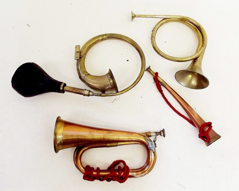 A copper bugle and three various brass horns
