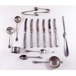 A silver and enamel sifter spoon, six silver handled tea knives, silver sugar tongs and various