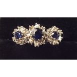 An 18 carat gold sapphire and diamond triple cluster ring
