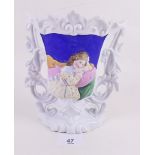 A 19th century porcelain vase with painted panel in relief depicting girl seated on settee