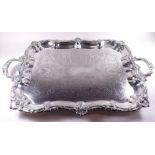 A large silver plated tray with scrollwork border