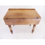 A 19th century pine side table with single drop flap all on turned supports