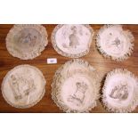 A group of twelve lace edged coasters, ten decorated with political cartoons and two with scenes