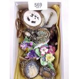 A box of vintage brooches