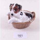 A Royal Doulton puppy in a basket - HN2587