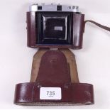 A Balda folding camera in leather case