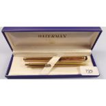 A Waterman gilt fountain pen, boxed and a Papermate biro