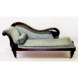 A Victorian chaise lounge with scroll carved back and end all raised on turned supports