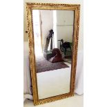 An antique full length gilt moulded mirror