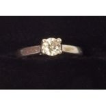 A platinum solitaire diamond ring with cross over setting - approx 1/4 carat (with original