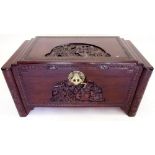 A carved camphorwood chest with ornate brass clasp and lock