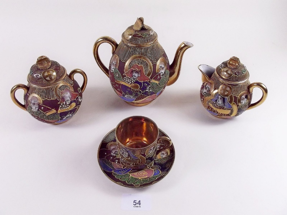 A Japanese late Satsuma coffee set comprising: six cups and saucers, coffee pot, jug and sugar