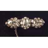A Victorian white metal brooch set central marquise cut diamond flanked by two pear cut stones,