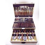 A plated cutlery set with wooden handles, cased