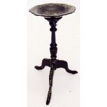 A Victorian black and gilt papier mache dish on tripod stand