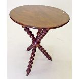 A Victorian walnut gypsy table with united bobbin turned supports