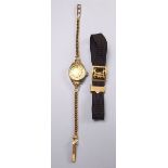 A gold ladies wrist watch and gold strap and a gold buckle and ribbon strap