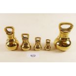A set of five brass bell weights