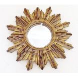 A gilt starburst mirror