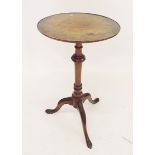 A burr walnut occasional table on turned column and triple supports