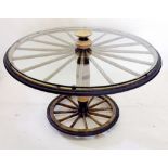 A wagon wheel form dinner table with glass top with 245cm diameter