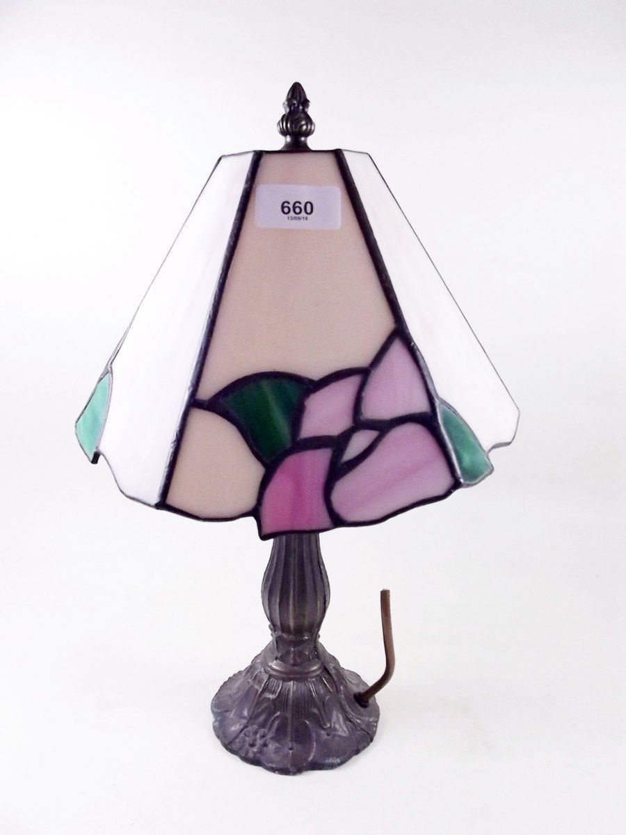 A bronze finish table lamp and glass shade