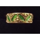 A gold and green enamel ring decorated leaves, unmarked 3g