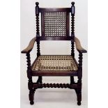 An early 20th century large cane open armchair with barleytwist supports