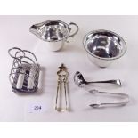 A Mappin & Webb silver plated toast rack, jug and bowl, two pairs of tongs and a sugar sifter