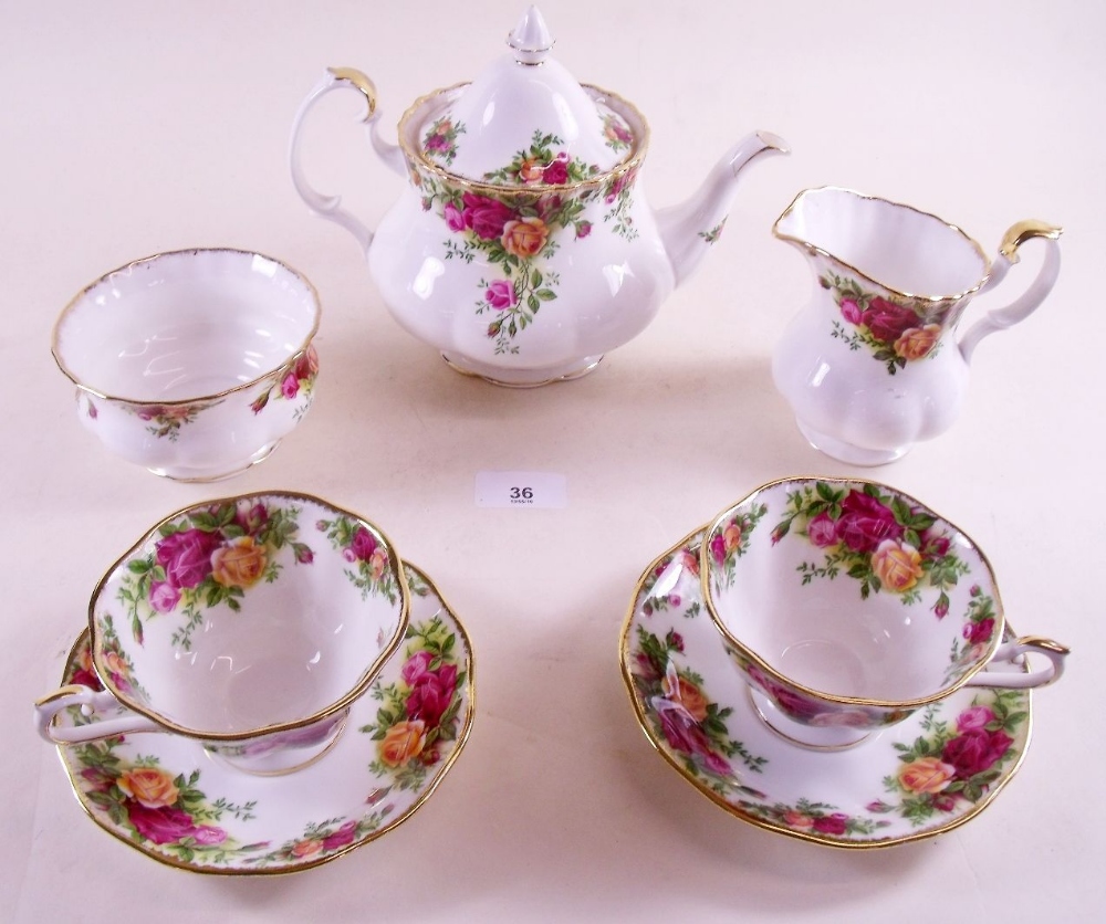A Royal Albert Country Roses tea service comprising: teapot, six cups and saucers, jug, sugar and