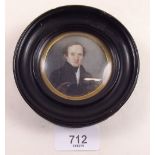 An early 19th century circular watercolour miniature of a young man - 5.5cm