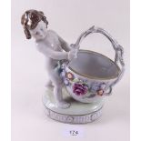 A porcelain cherub and floral basket