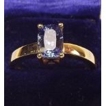 An 18 carat gold ring set cushion cut tanzanite