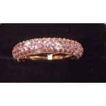An 18 carat gold eternity ring set pink sapphires and diamonds