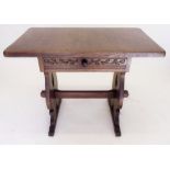 An oak side table with carved frieze on refectory style supports